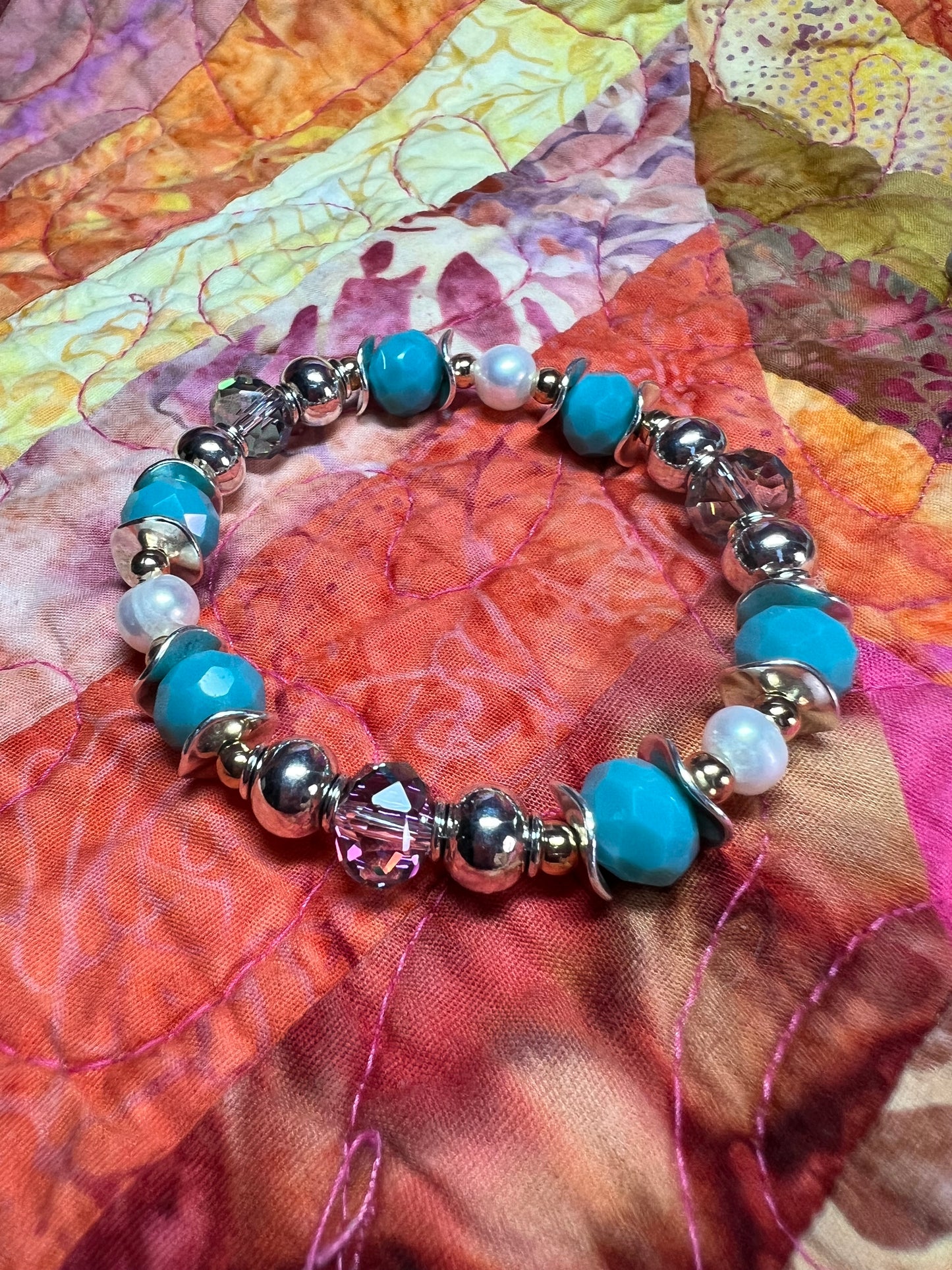 Bracelet- Gold and silver plated metal beads, crystals, & freshwater pearls.