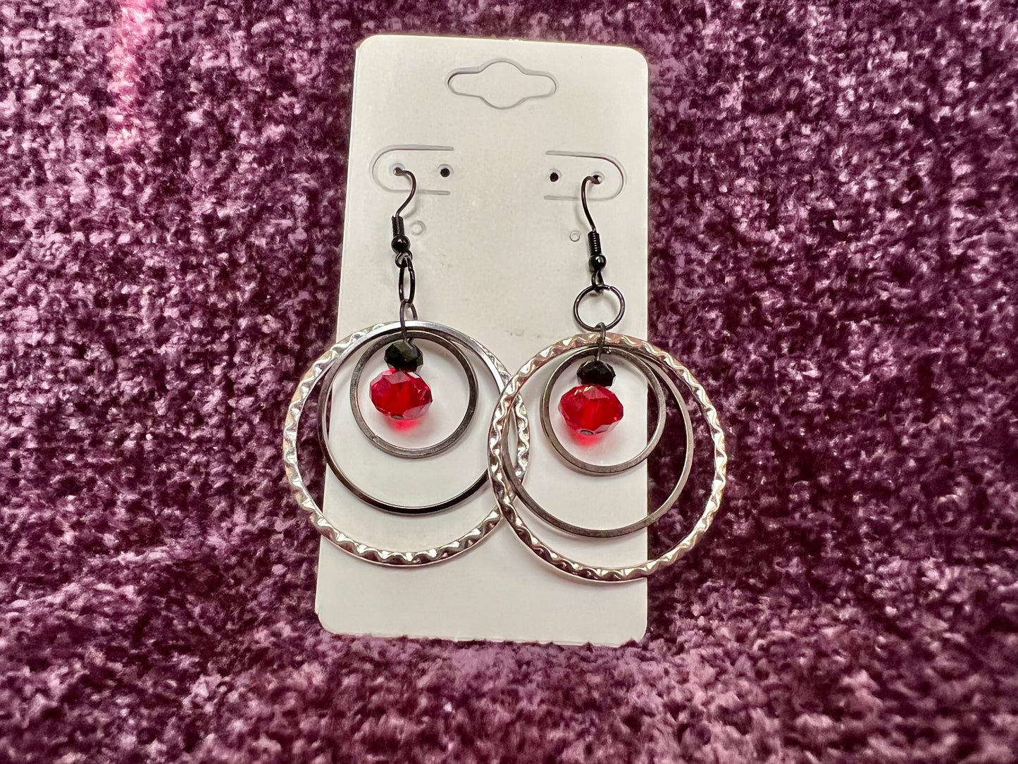 Earrings- Black coated stainless steel ear hooks with gunmetal and silver hoops. Red and black crystals.