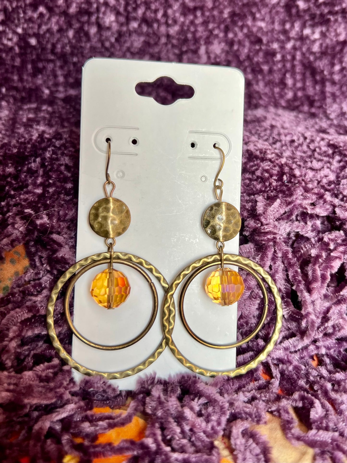 Earrings- Antique gold plated metal with yellowish orange colored crystal.