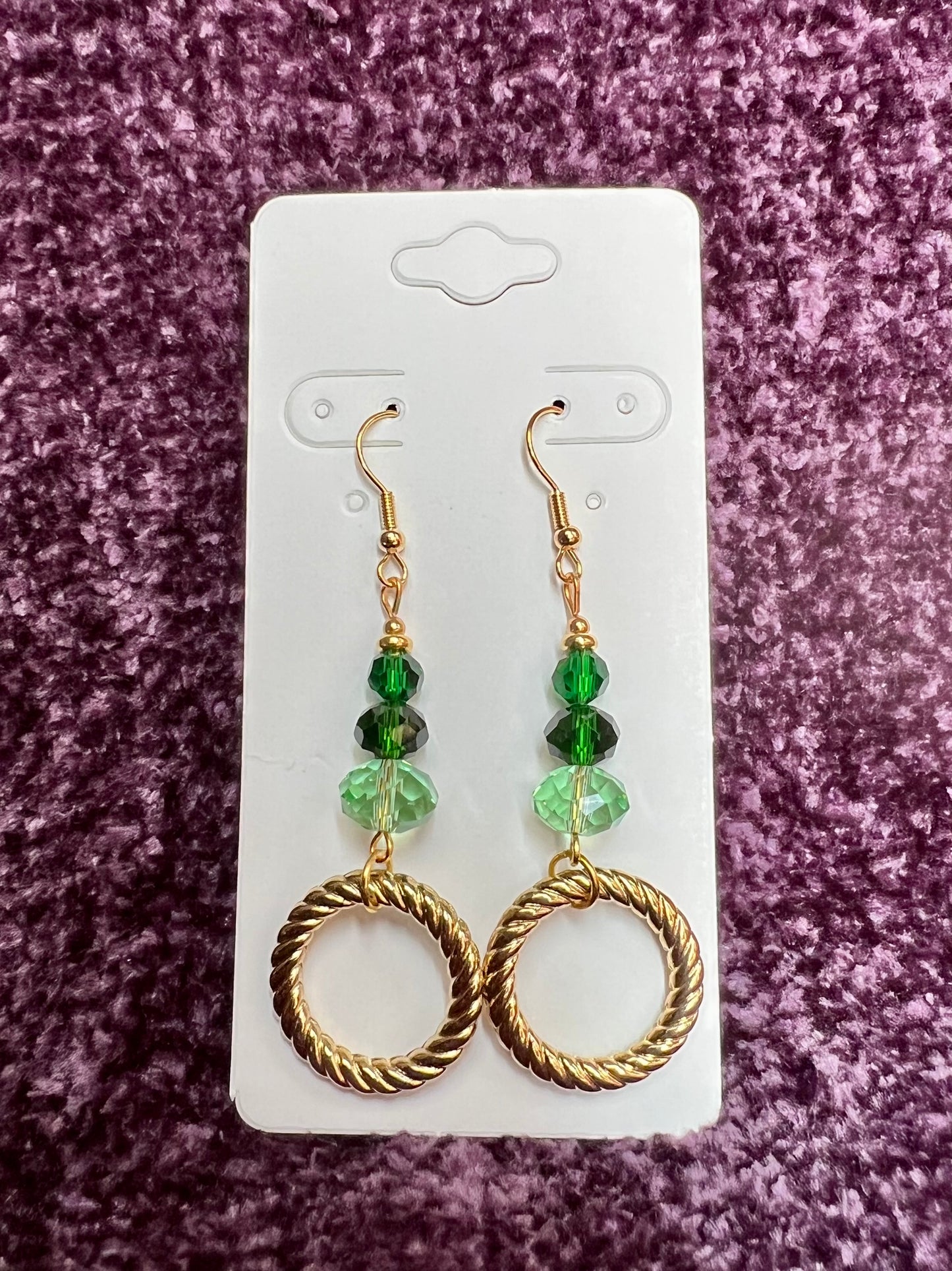 Earrings- Gold plated stainless steel ear hooks, gold plated metal with various green colored crystals.