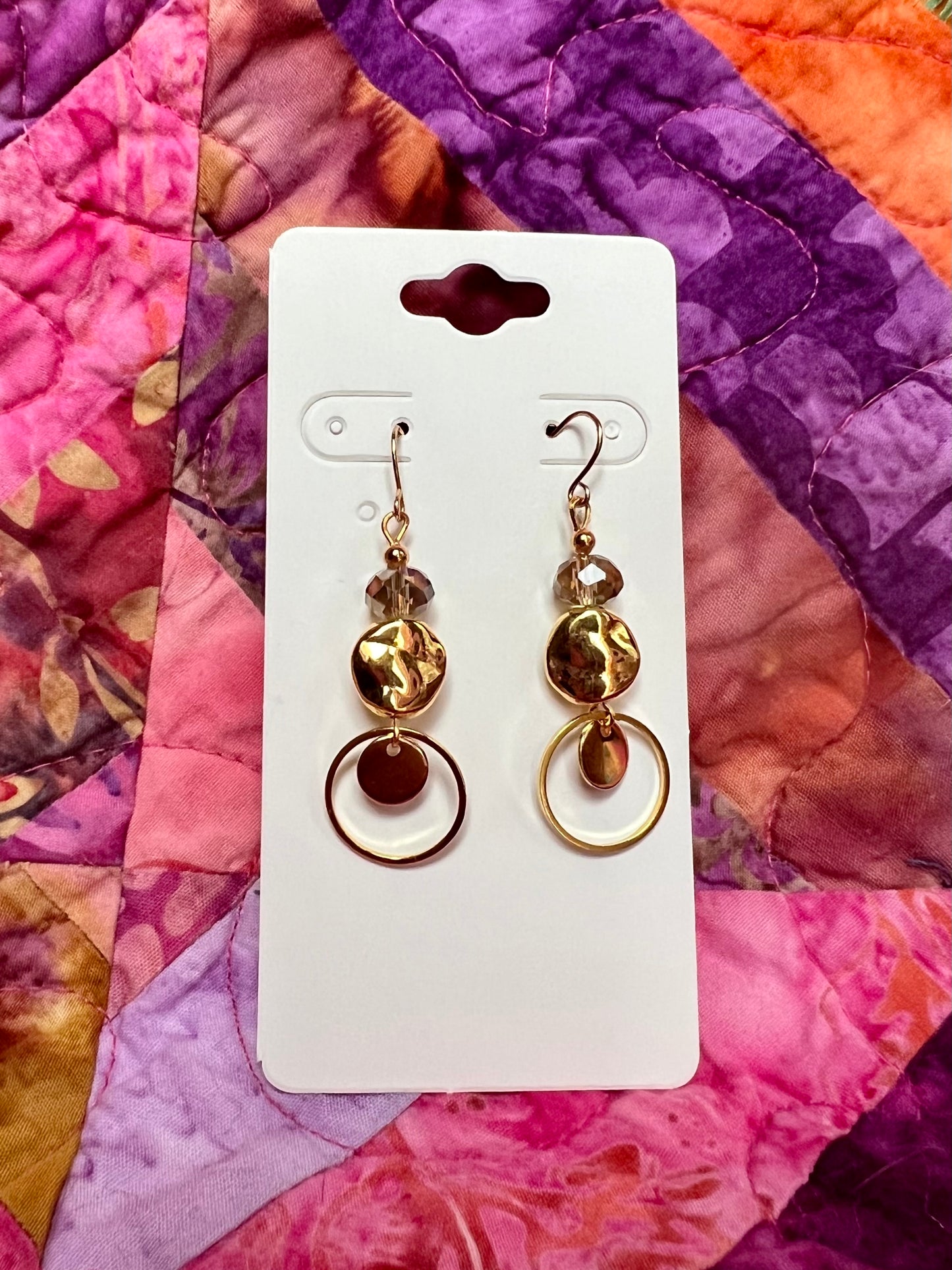 Earrings- Gold plated metal with champagne colored crystals.