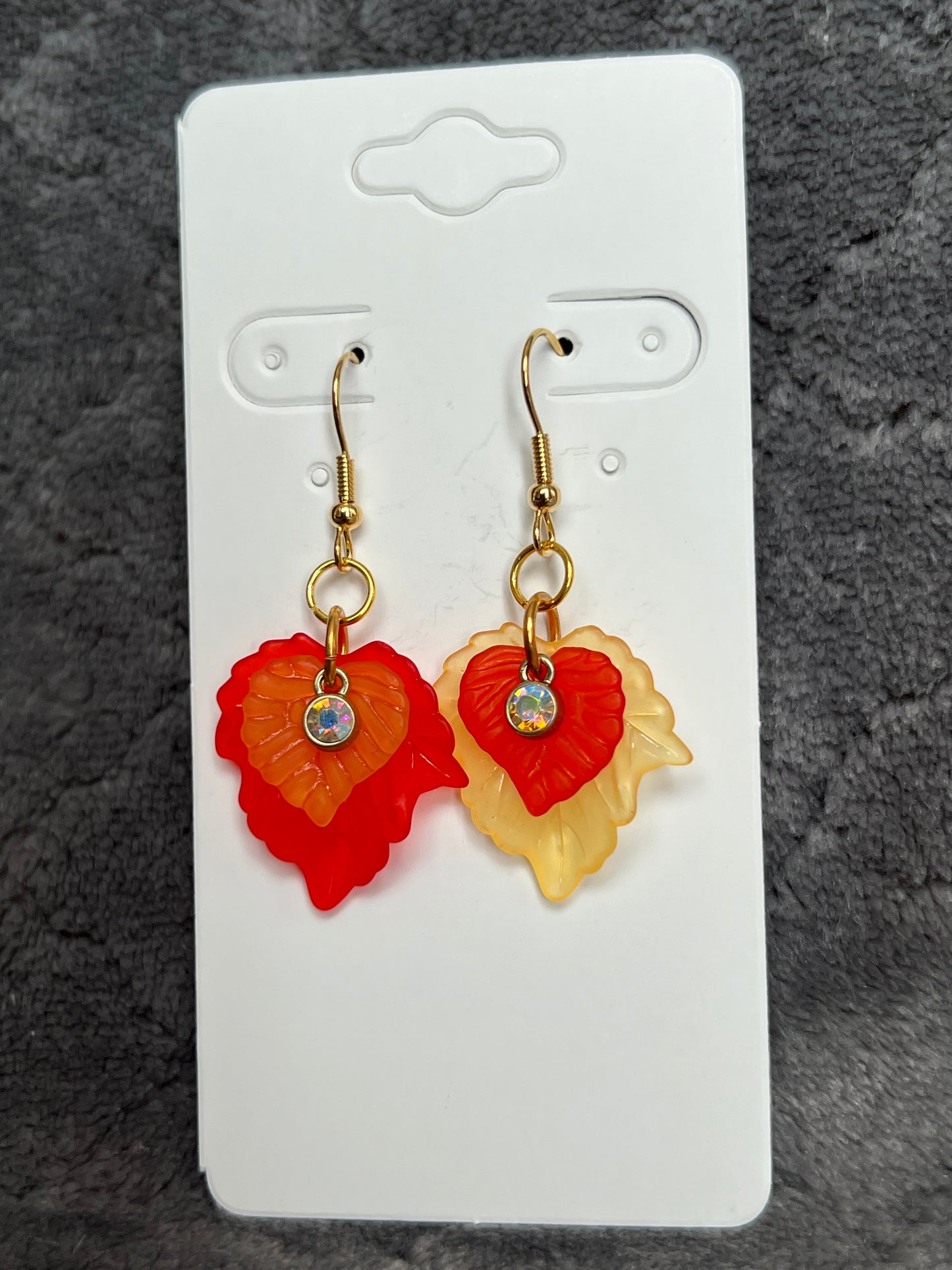 Earrings- Acrylic orange and red leaves with gold plated metal and AB crystals.