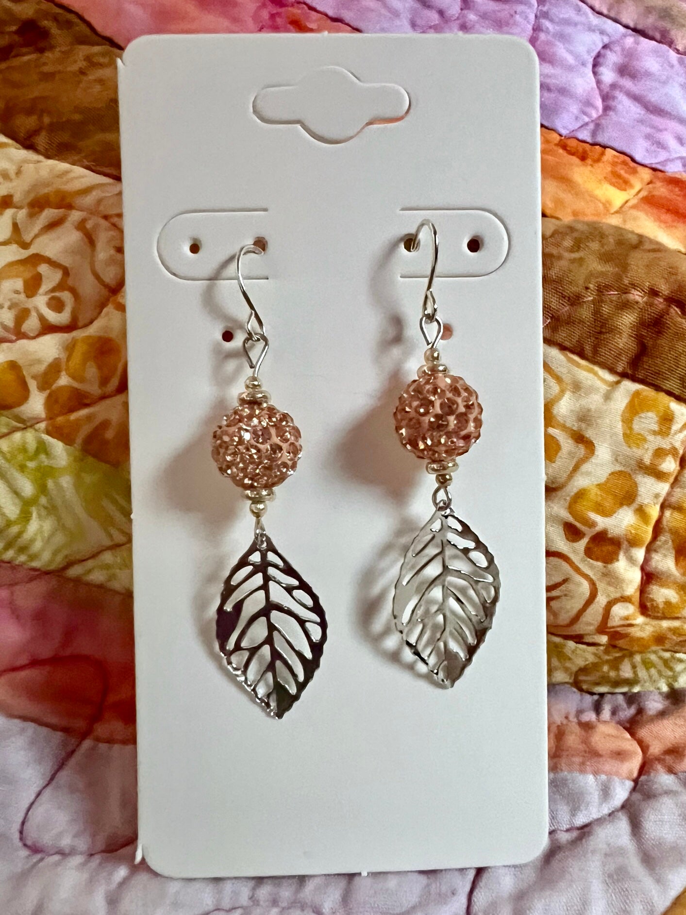Earrings- Silver plated ear wires and metal leaves with peach colored clay and rhinestone beads.