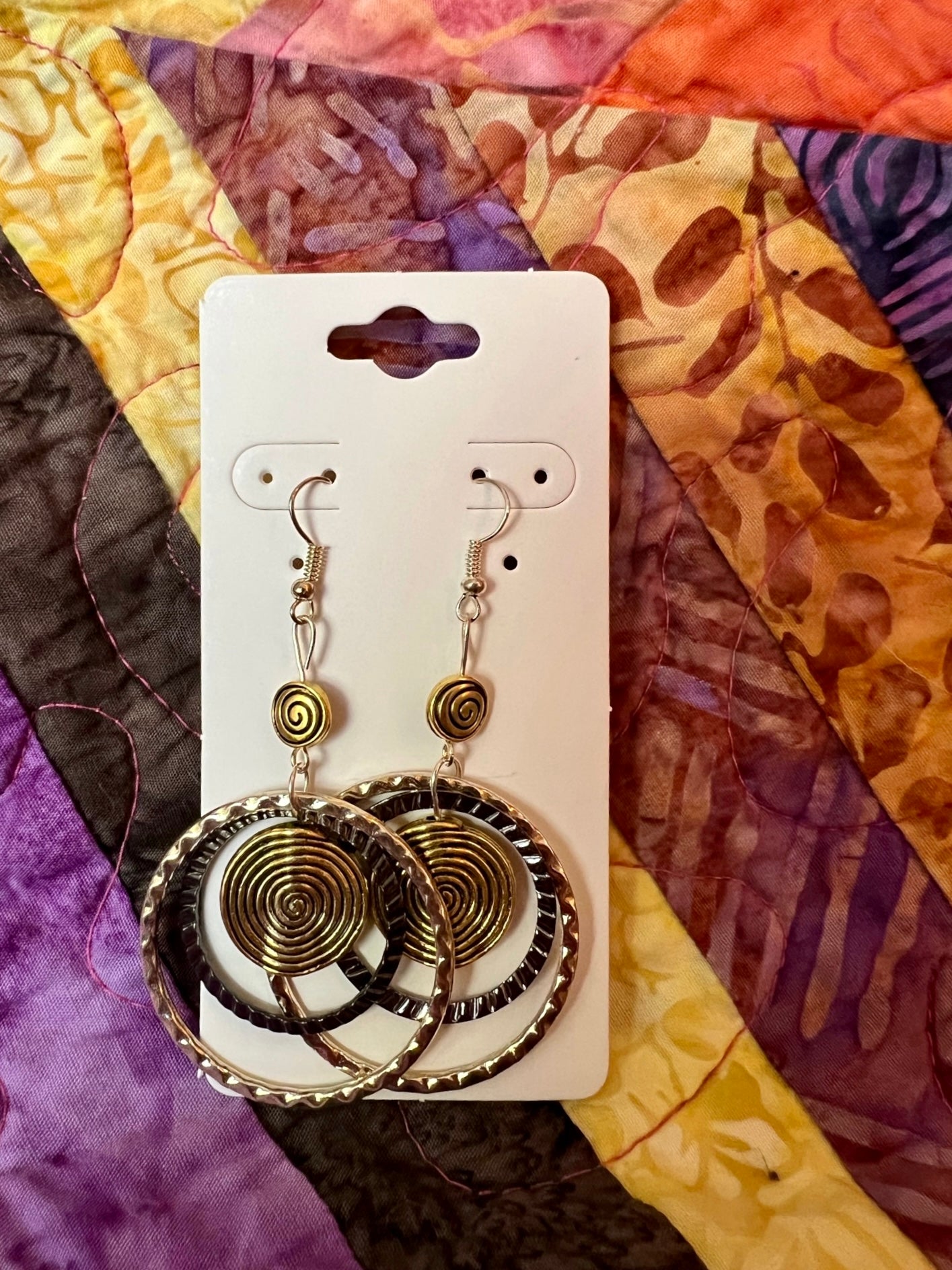 Earrings- Gold, silver, and gun metal plated hoops and beads.