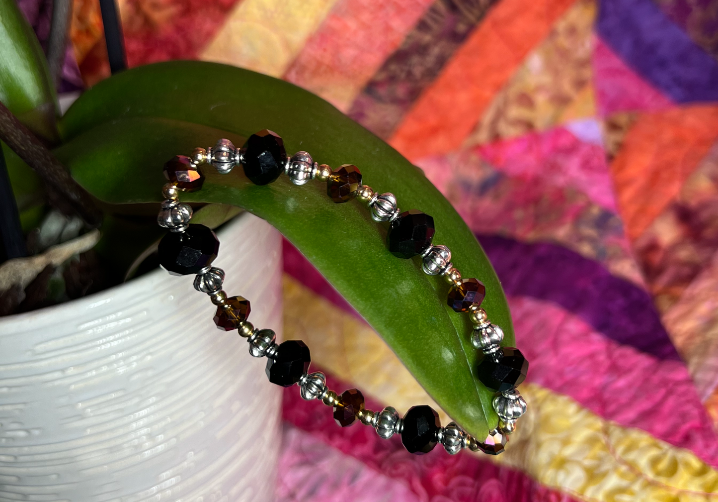 Bracelet- Silver and gold plated metal beads with black & brown topaz crystals.