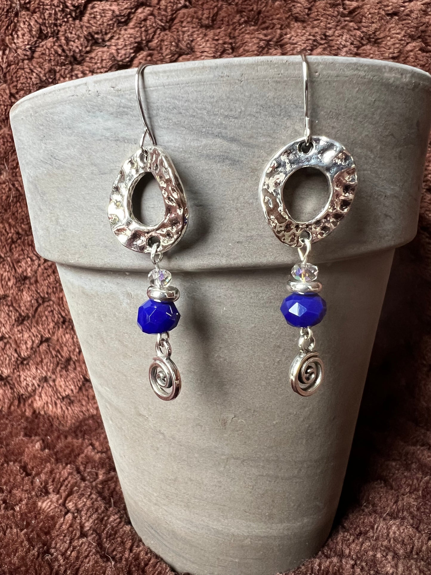 Earrings- Silver plated antiqued metal with small AB clear crystals and dark blue crystals.