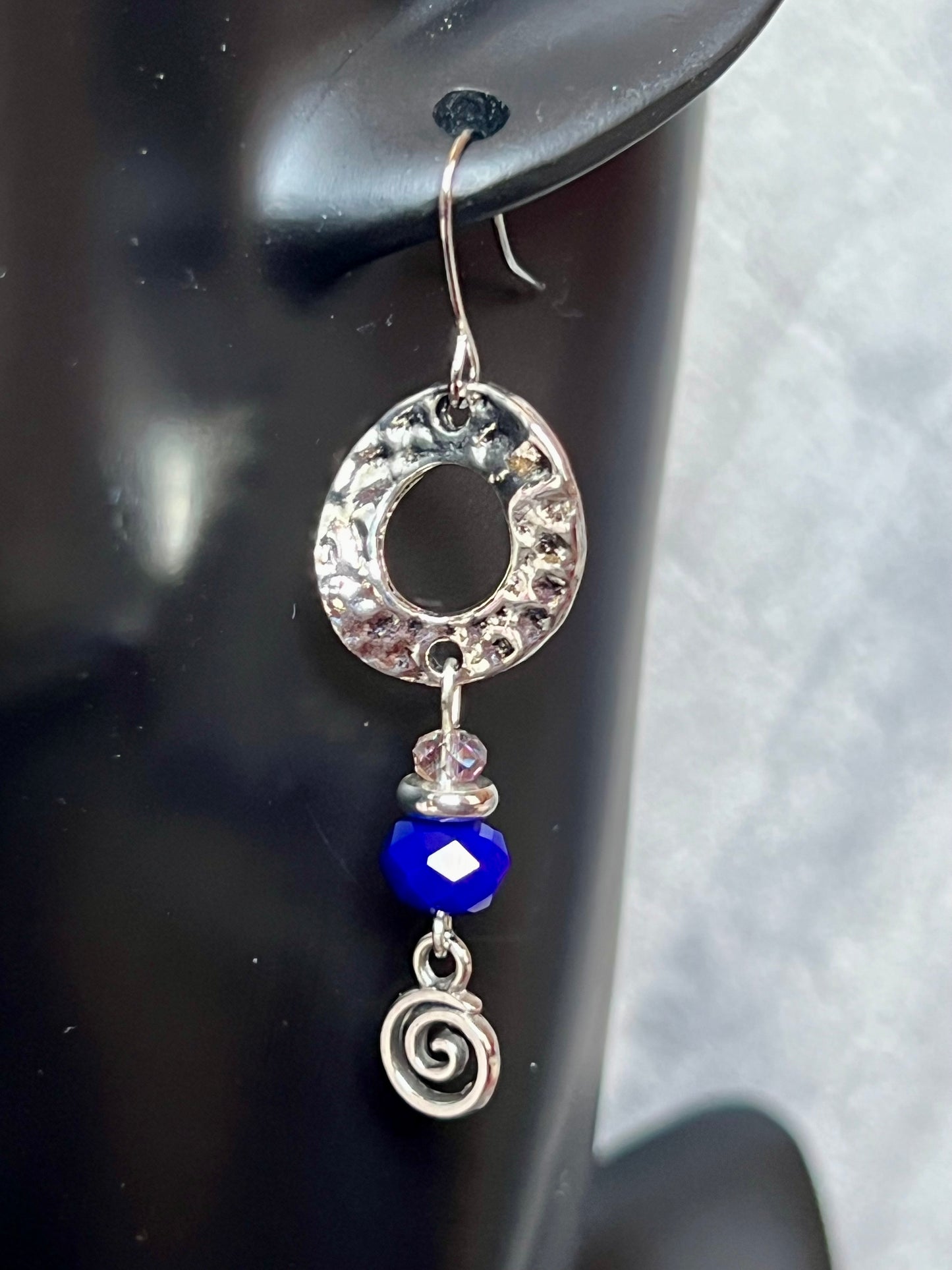 Earrings- Silver plated antiqued metal with small AB clear crystals and dark blue crystals.