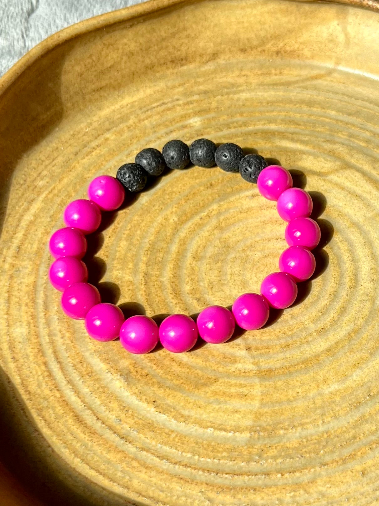 Bracelet- pink beads with black lava stone beads for essential oils.