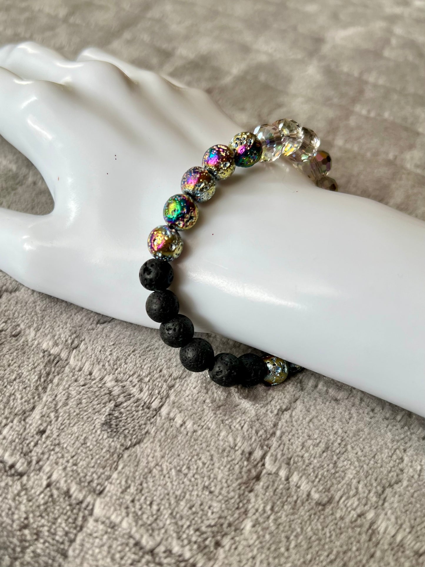 Bracelet- rainbow coated lava beads, round faceted AB crystals, with black lava stone beads for essential oils.