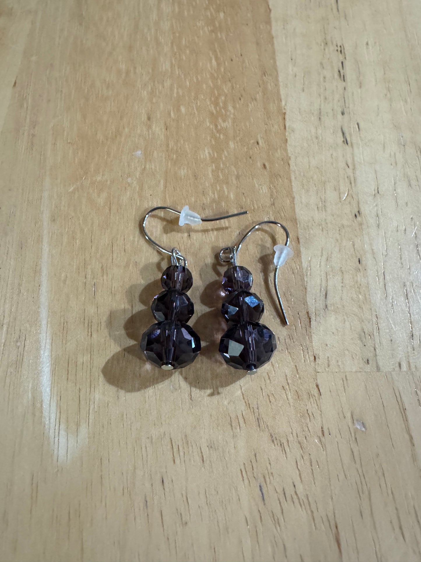 Earrings- Stainless steel ear hooks, silver plated metal with opaque black crystals.
