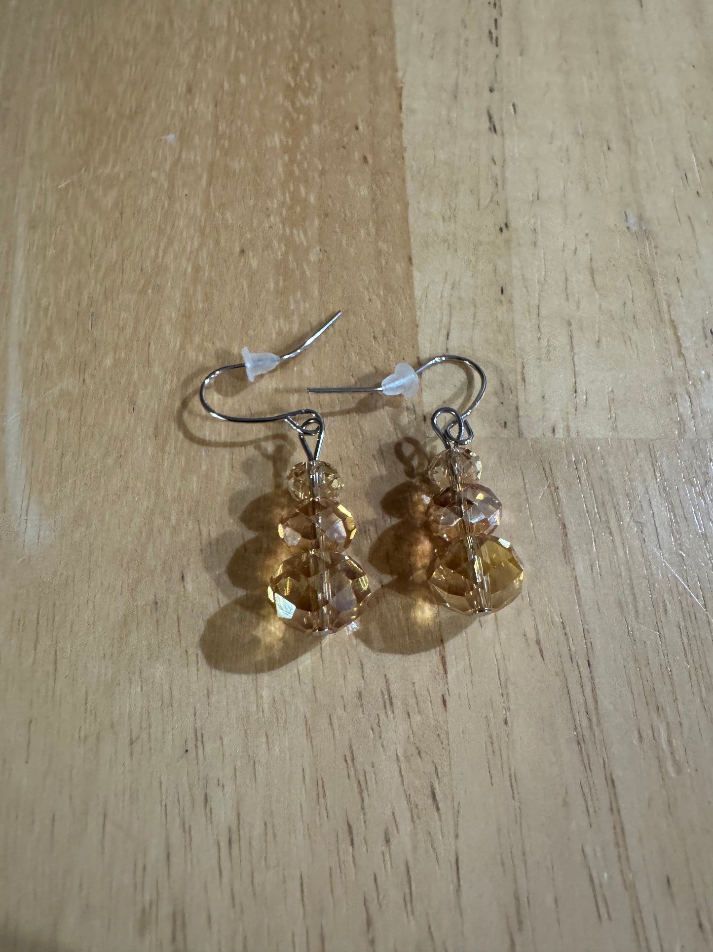 Earrings- Stainless steel ear hooks, silver plated metal with opaque black crystals.