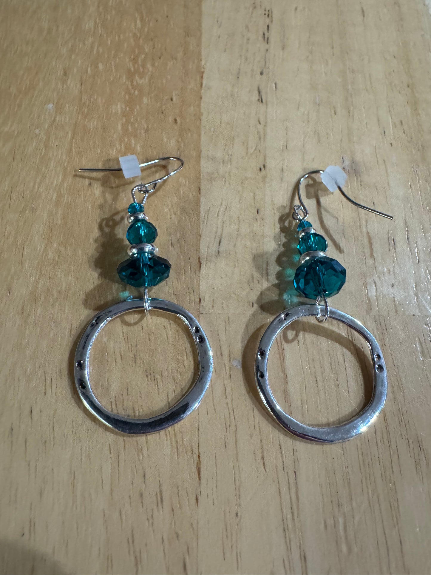 Earrings- Stainless steel ear hooks, silver plated metal with opaque black crystals.