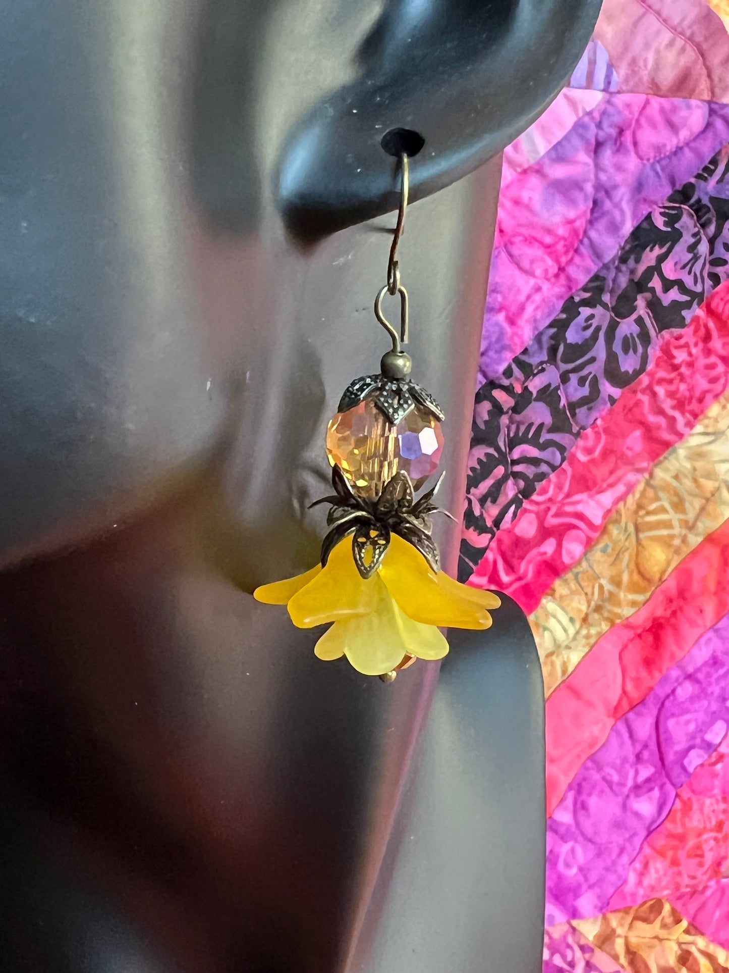 Earrings- Antique gold plated metal with acrylic yellow flower beads and crystal beads.