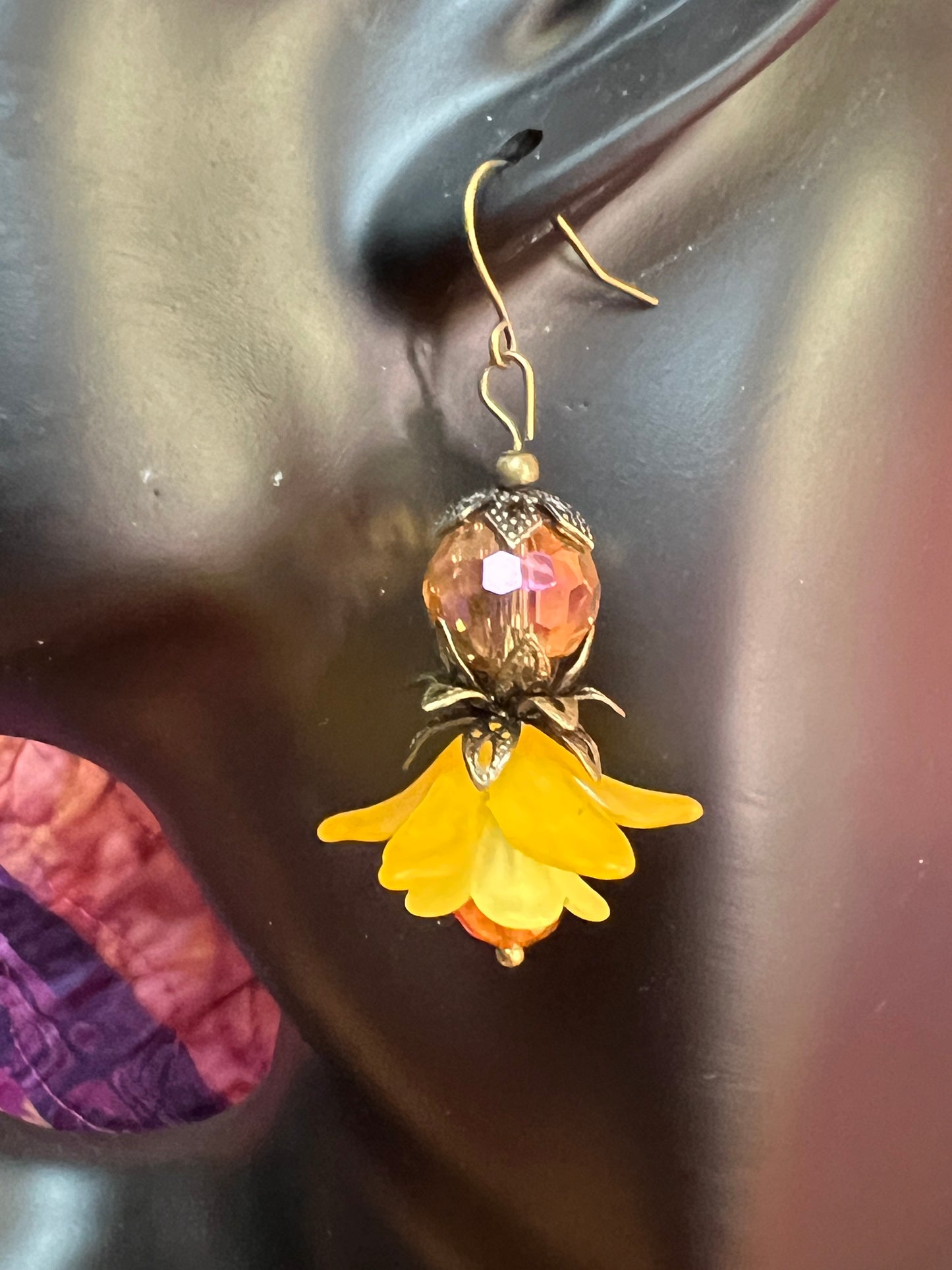 Earrings- Antique gold plated metal with acrylic yellow flower beads and crystal beads.