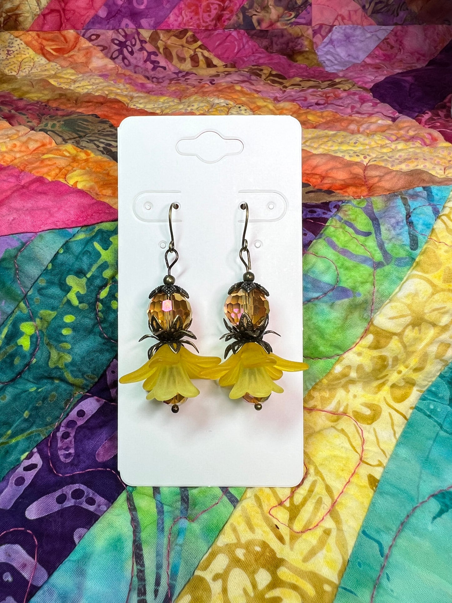 Earrings- Antique gold plated metal with acrylic yellow flower beads and crystal beads.