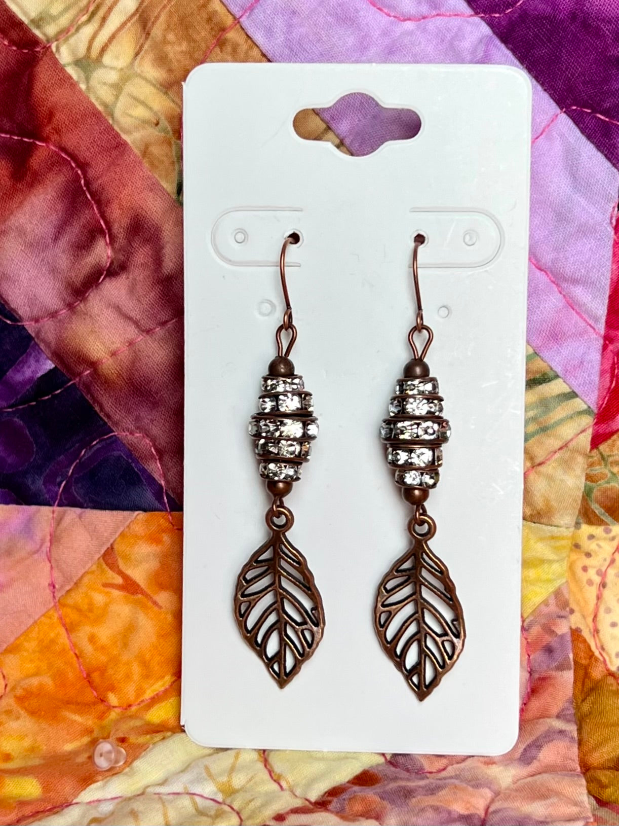 Earrings- Antique copper plated metal leaves with clear crystal rondelles.