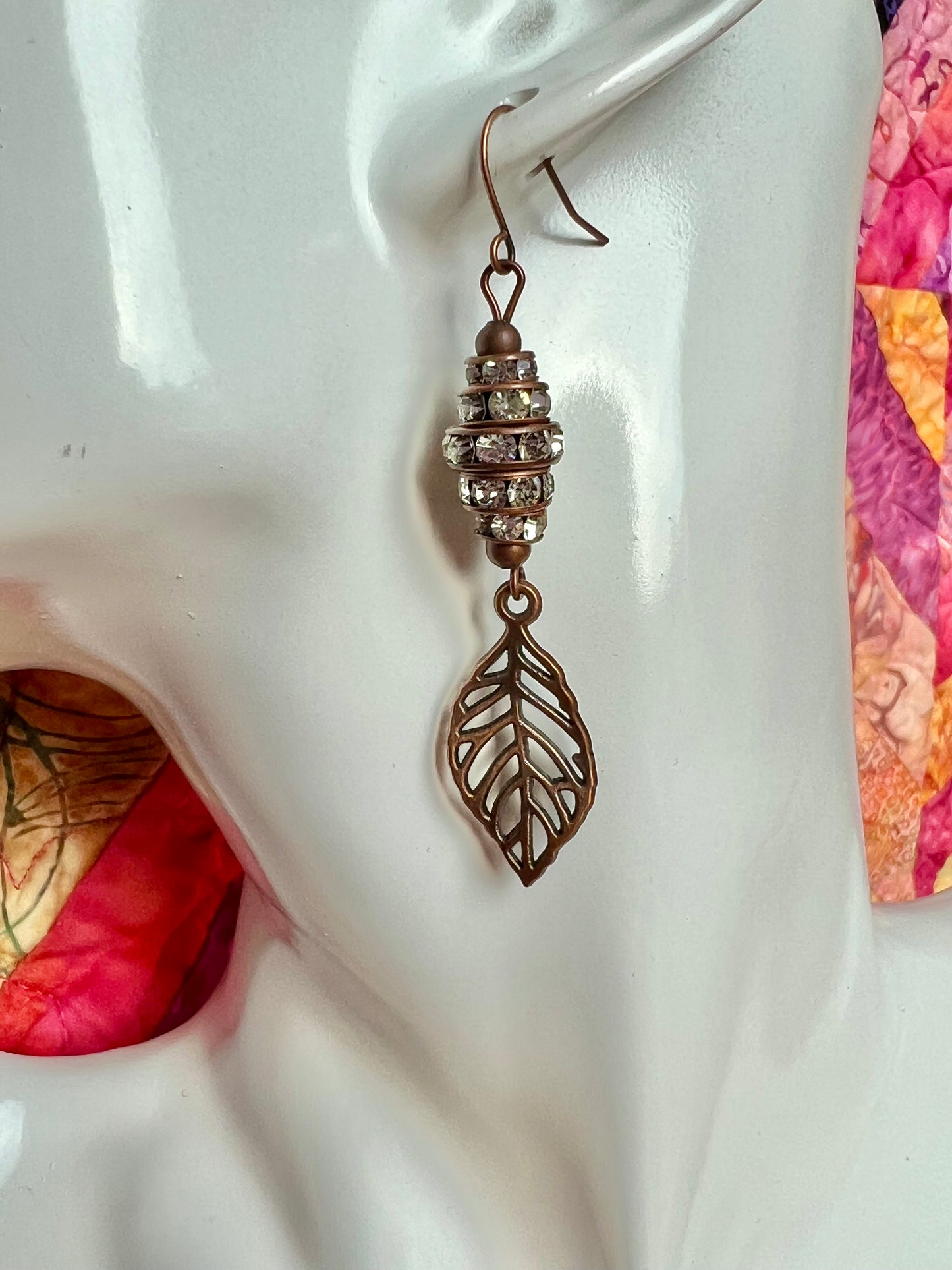 Earrings- Antique copper plated metal leaves with clear crystal rondelles.