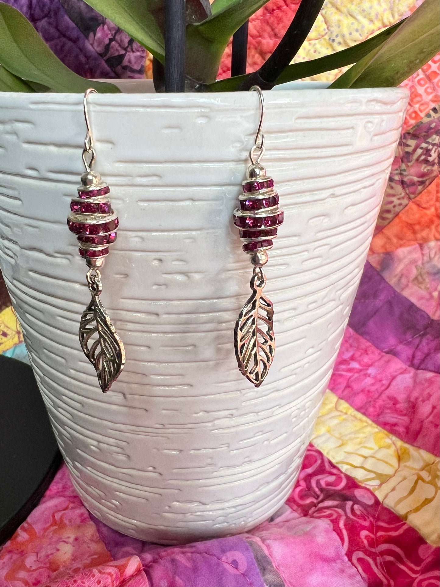 Earrings- Silver plated metal leaves with fuchsia colored crystal rondelles.