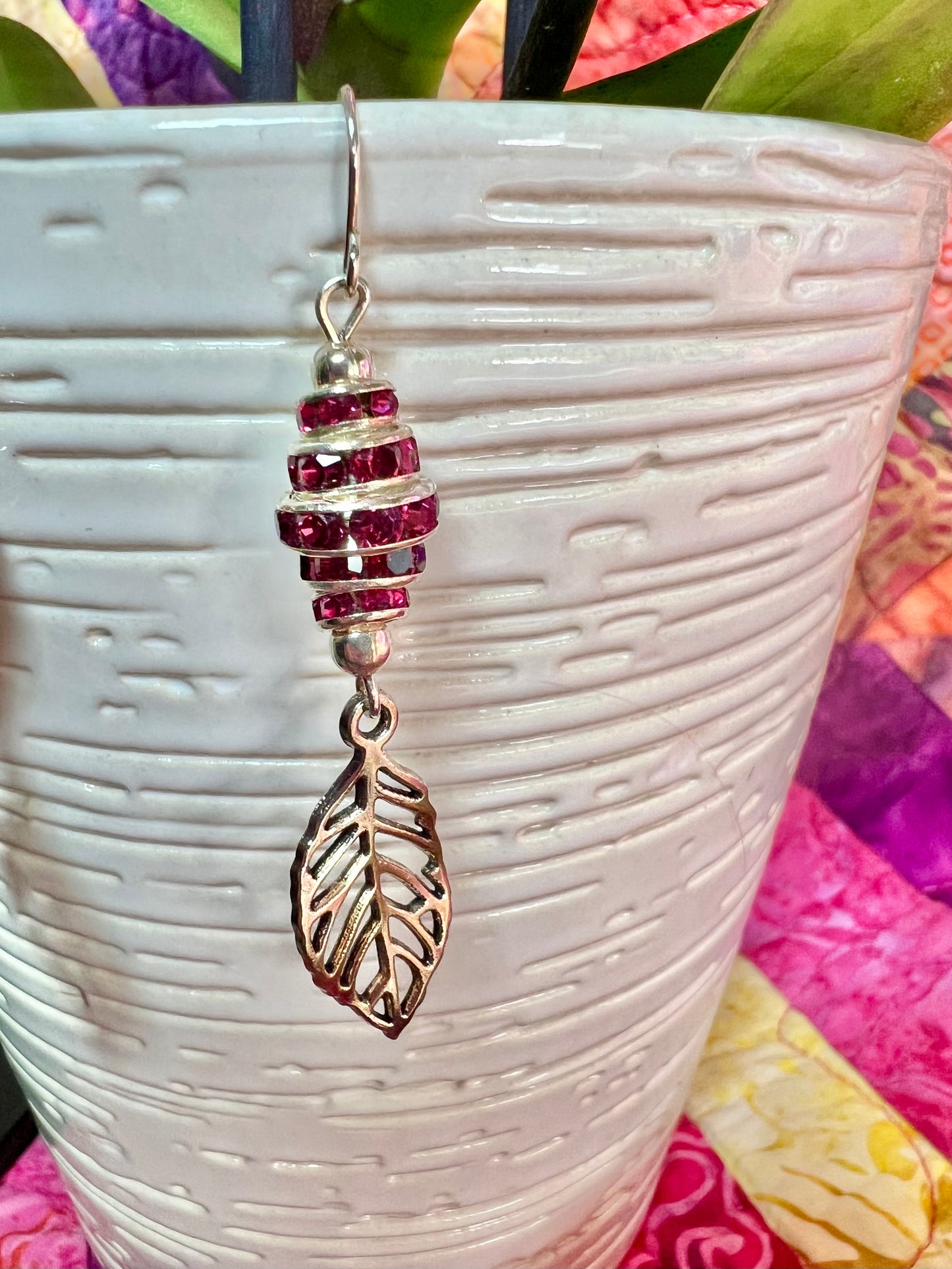 Earrings- Silver plated metal leaves with fuchsia colored crystal rondelles.