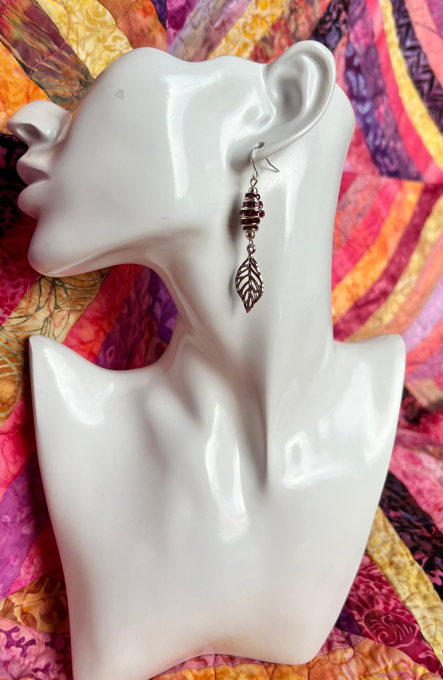 Earrings- Silver plated metal leaves with fuchsia colored crystal rondelles.