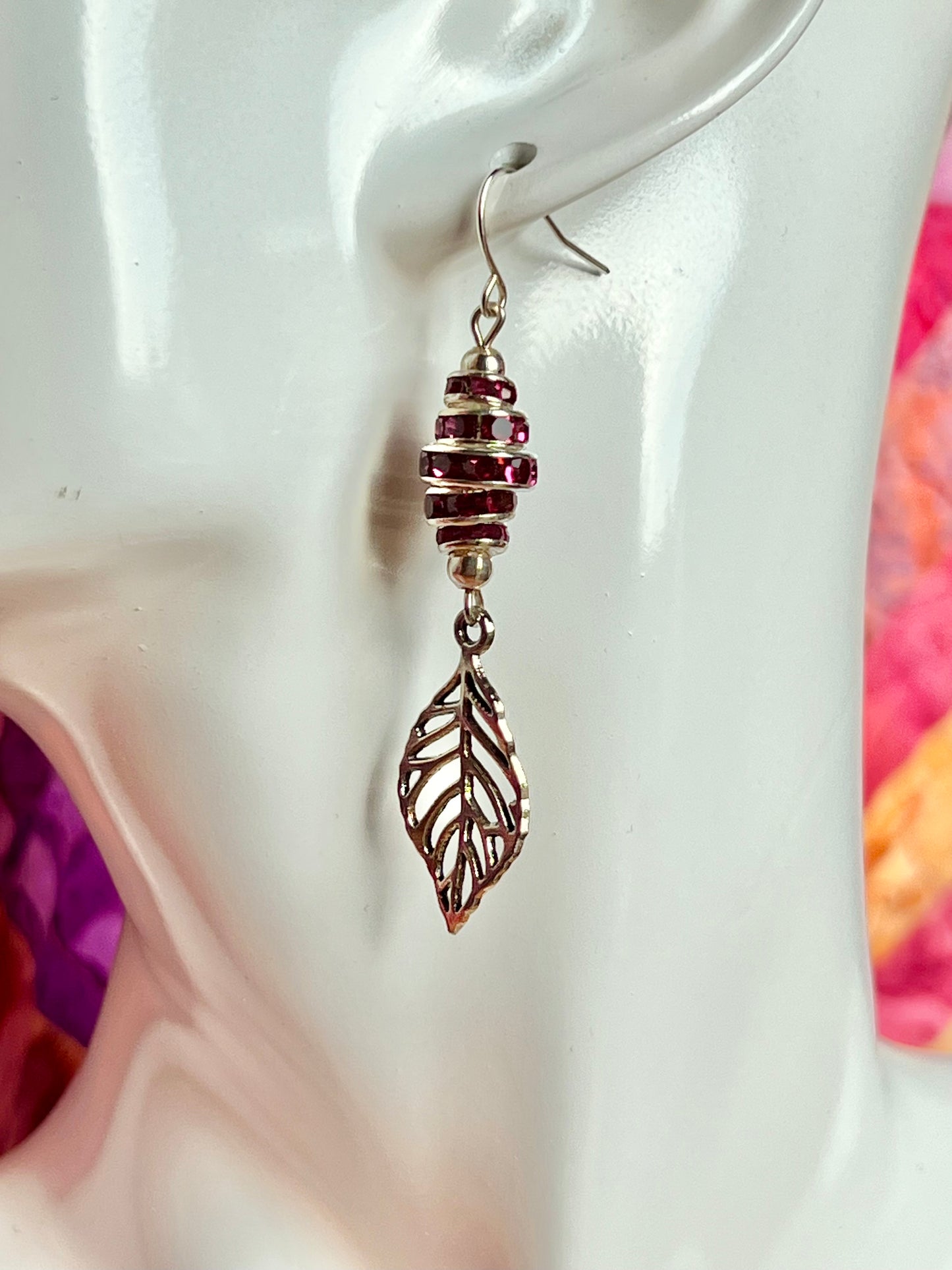 Earrings- Silver plated metal leaves with fuchsia colored crystal rondelles.