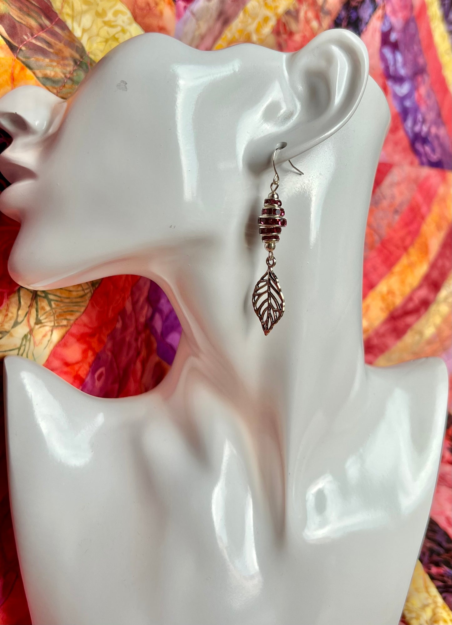 Earrings- Silver plated metal leaves with fuchsia colored crystal rondelles.