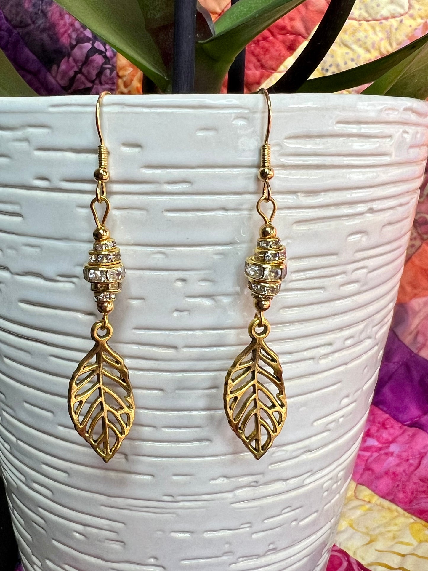 Earrings- Gold plated metal leaves with clear crystal rondelles.