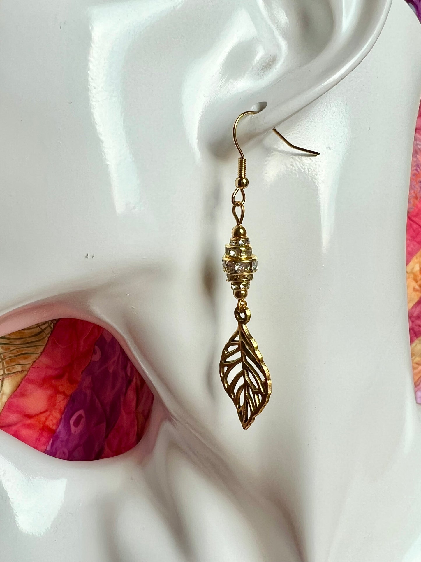 Earrings- Gold plated metal leaves with clear crystal rondelles.