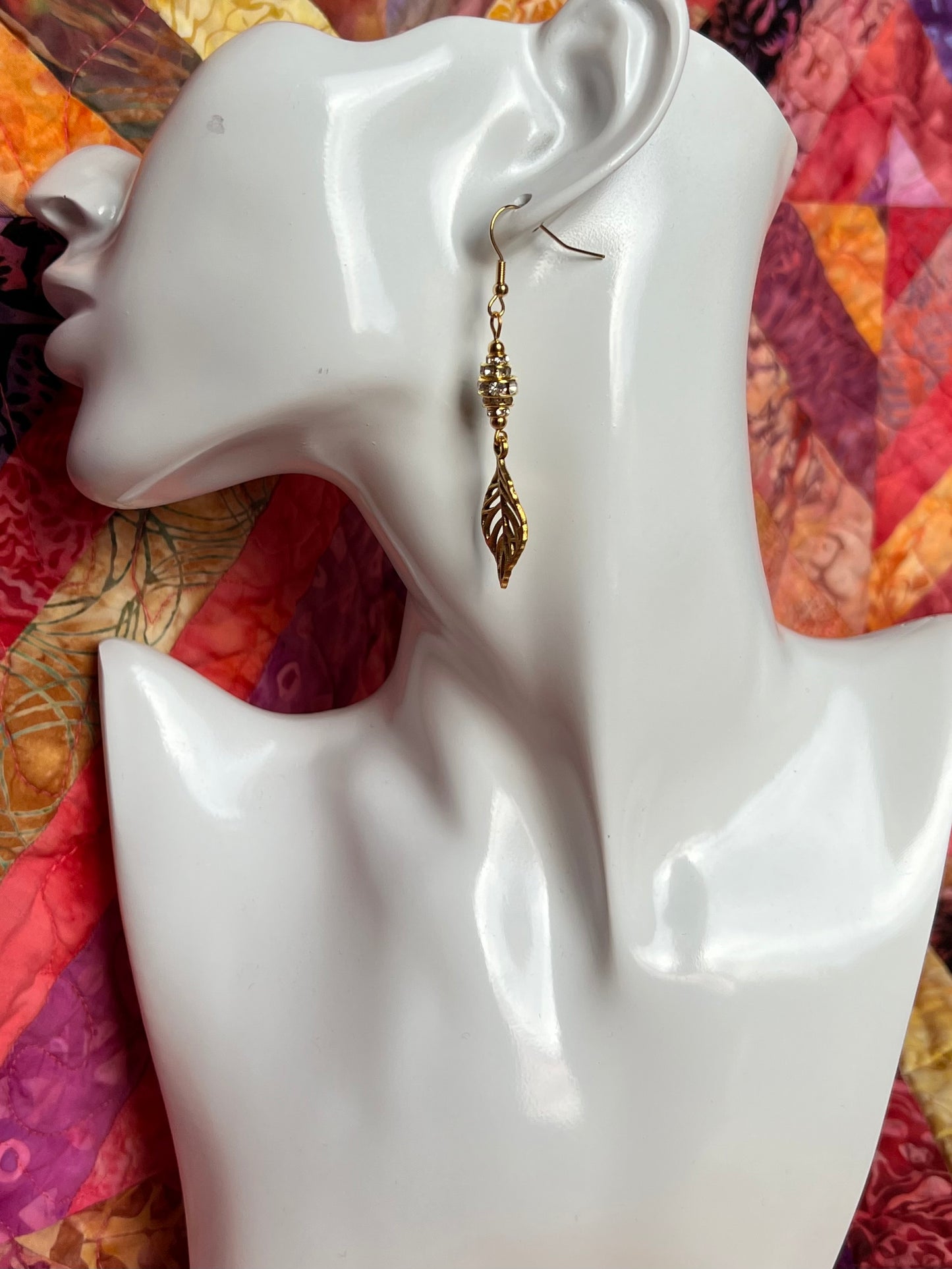 Earrings- Gold plated metal leaves with clear crystal rondelles.