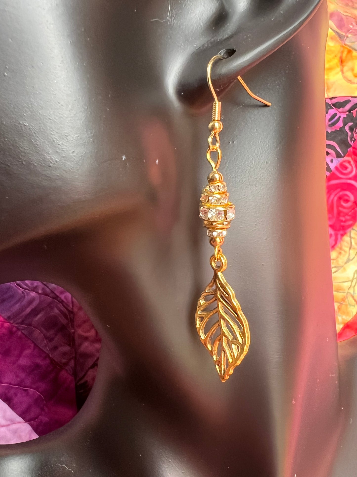 Earrings- Gold plated metal leaves with clear crystal rondelles.