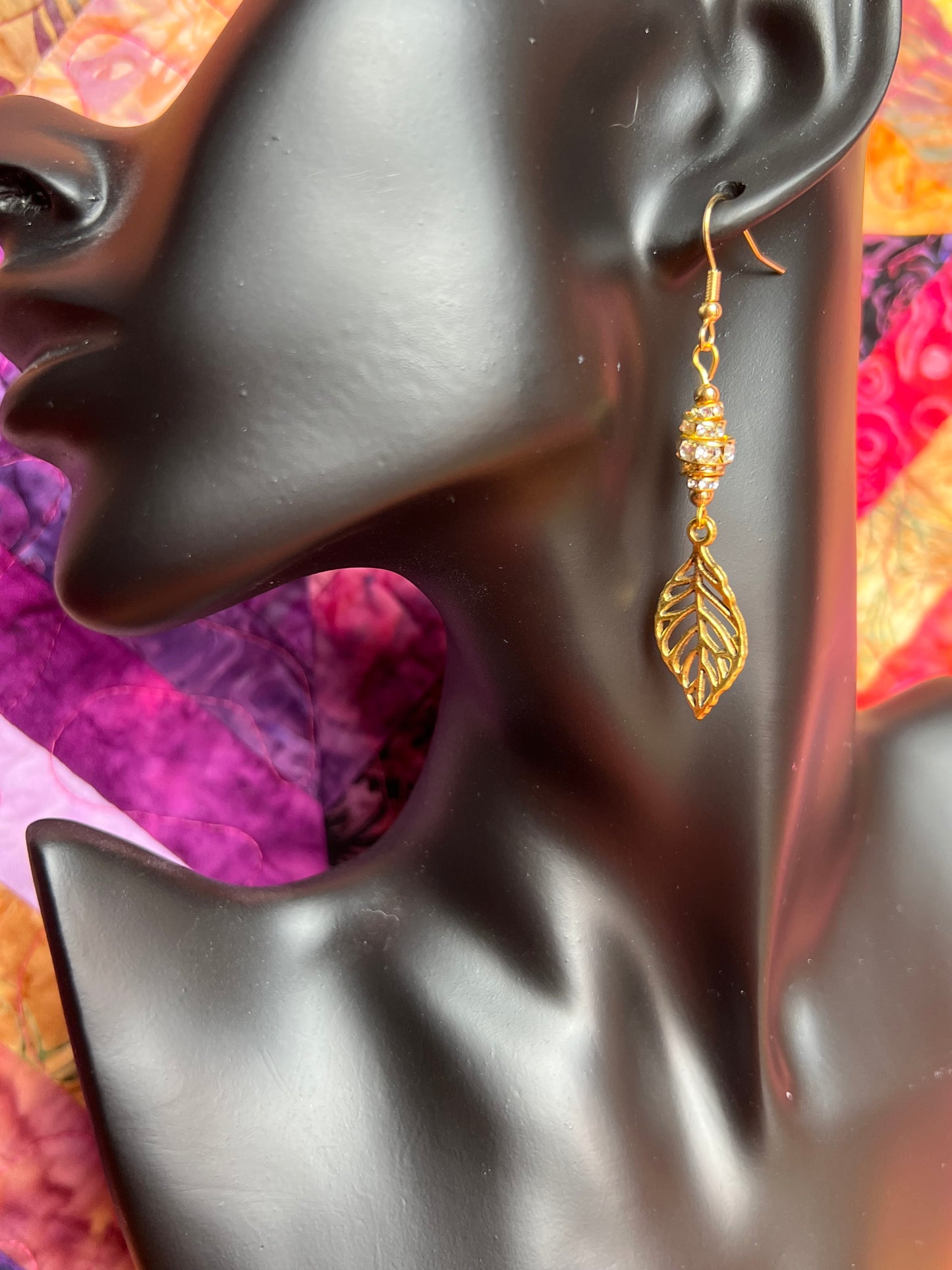 Earrings- Gold plated metal leaves with clear crystal rondelles.