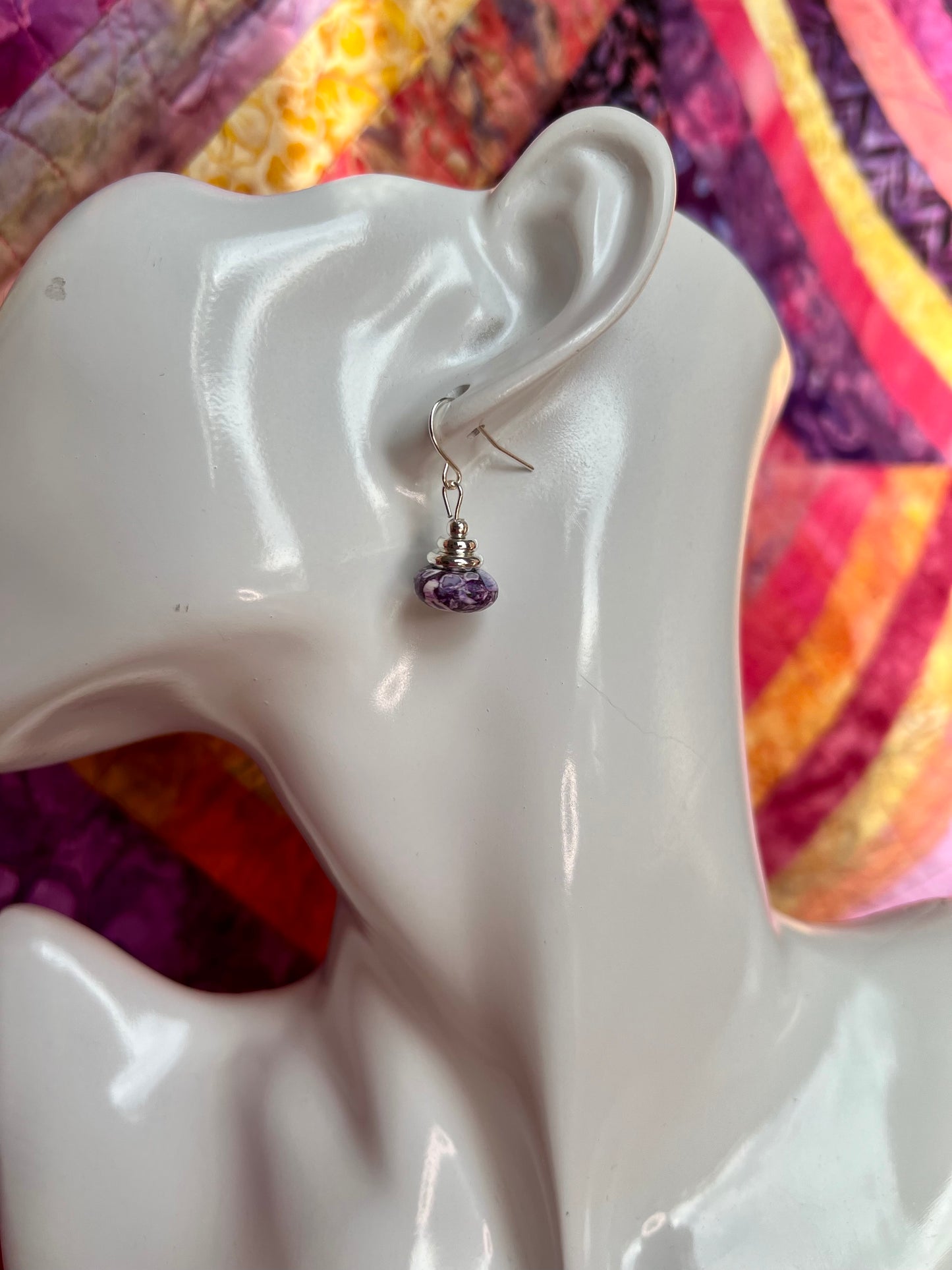 Earrings- Silver plated metal with purple dyed stone.