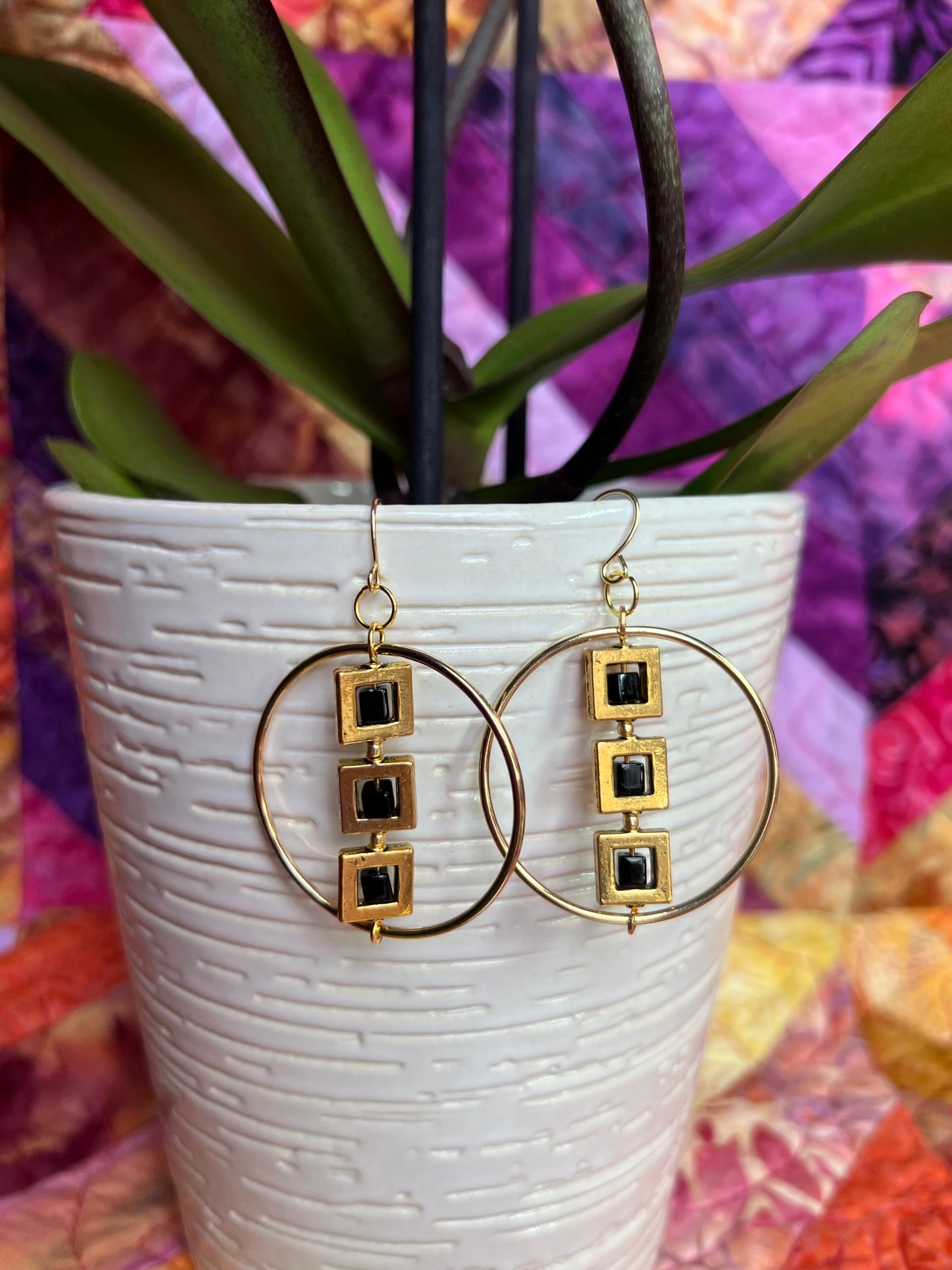 Earrings- Gold plated metal hoops with squares and black cube seed beads.