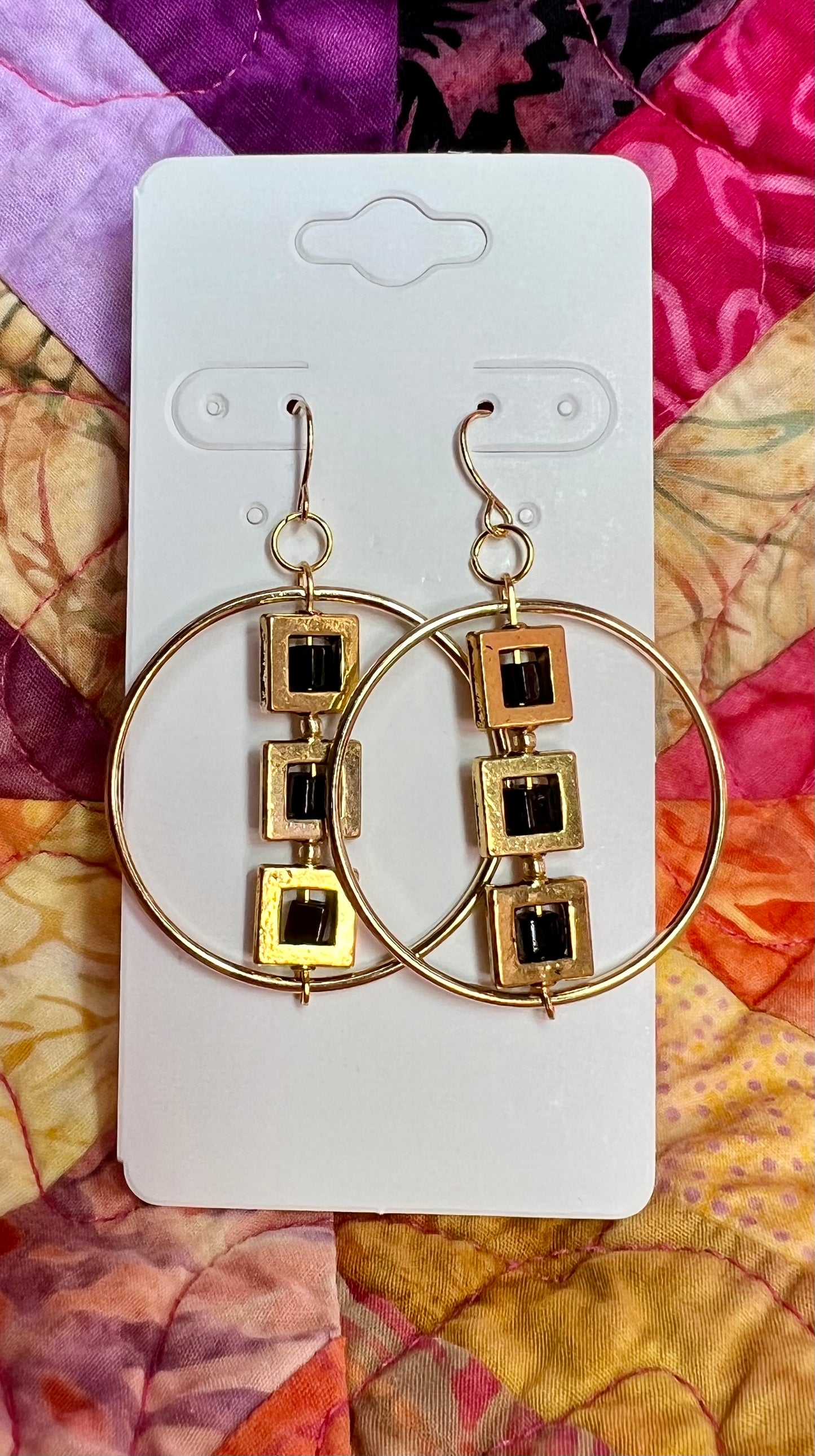 Earrings- Gold plated metal hoops with squares and black cube seed beads.