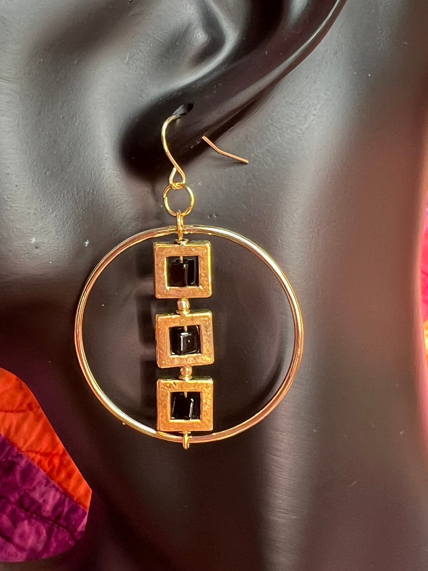 Earrings- Gold plated metal hoops with squares and black cube seed beads.