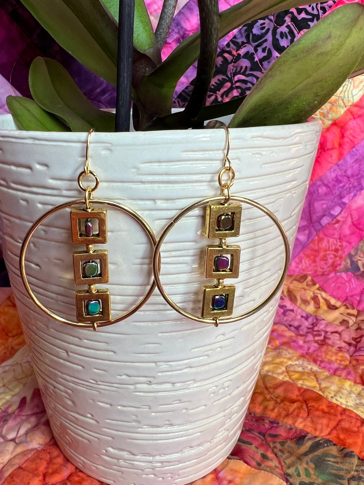 Earrings- Gold plated metal hoops with squares and metallic rainbow hematite cube seed beads.