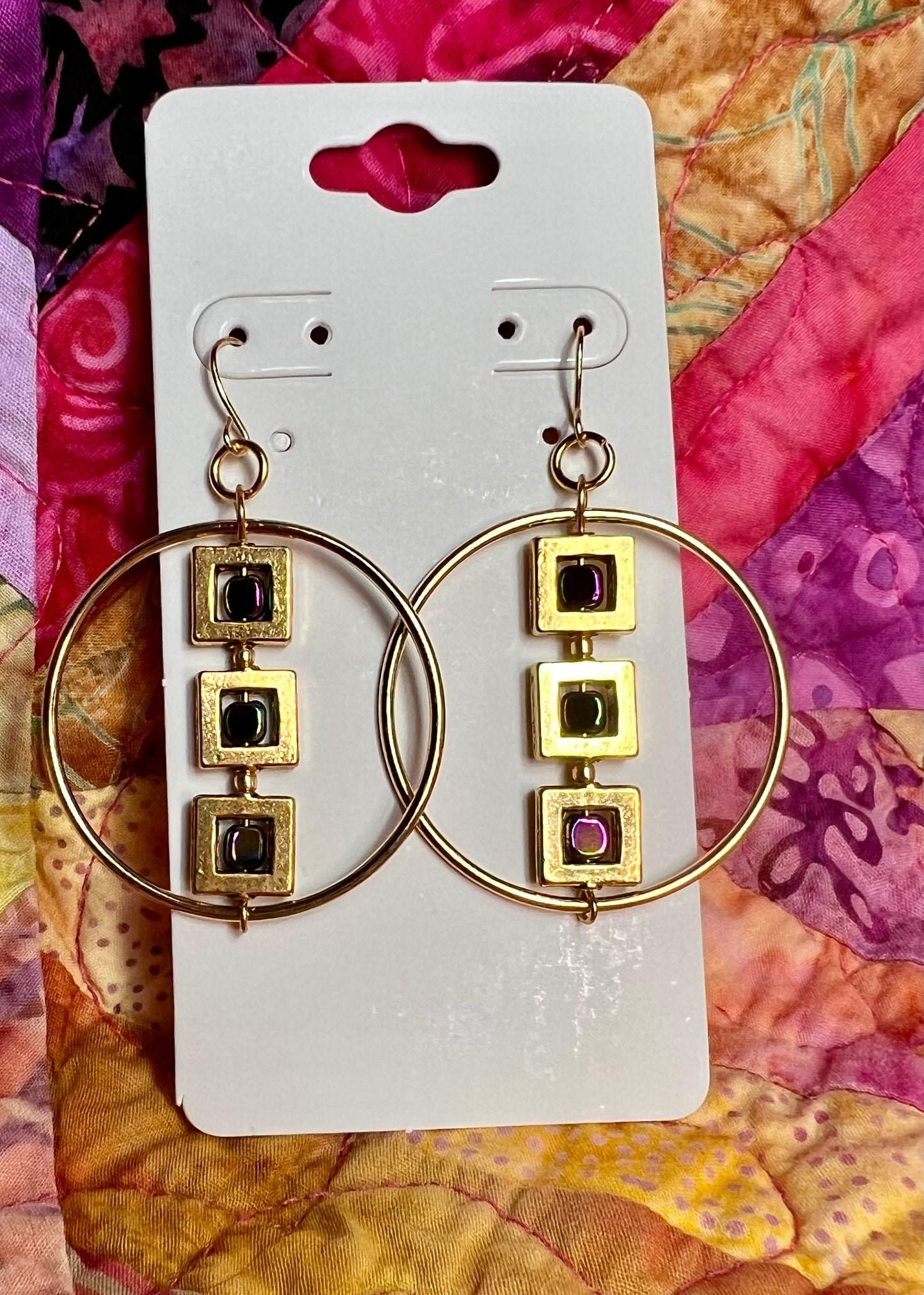 Earrings- Gold plated metal hoops with squares and metallic rainbow hematite cube seed beads.