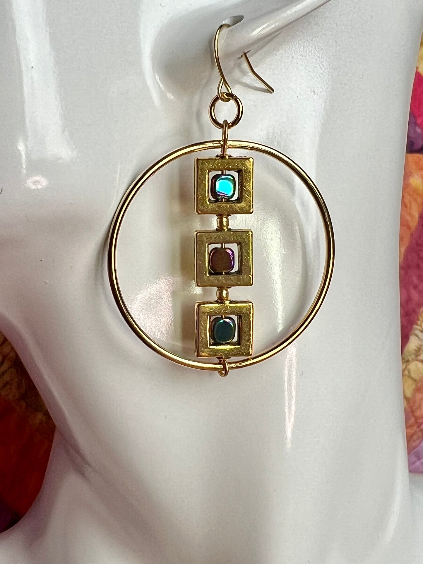 Earrings- Gold plated metal hoops with squares and metallic rainbow hematite cube seed beads.