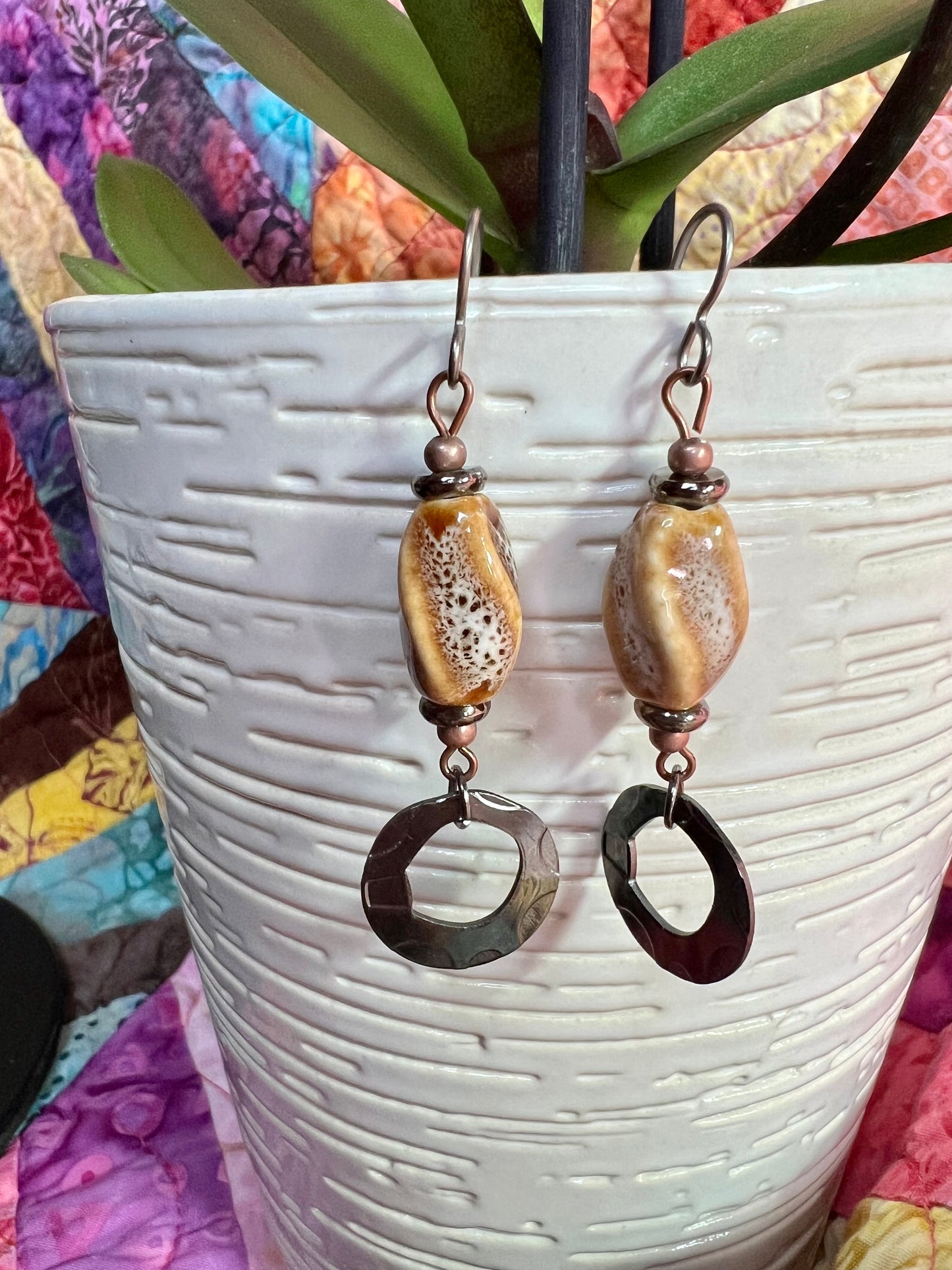 Earrings- Copper and gunmetal plated metal with tan and brown speckled ceramic center bead.