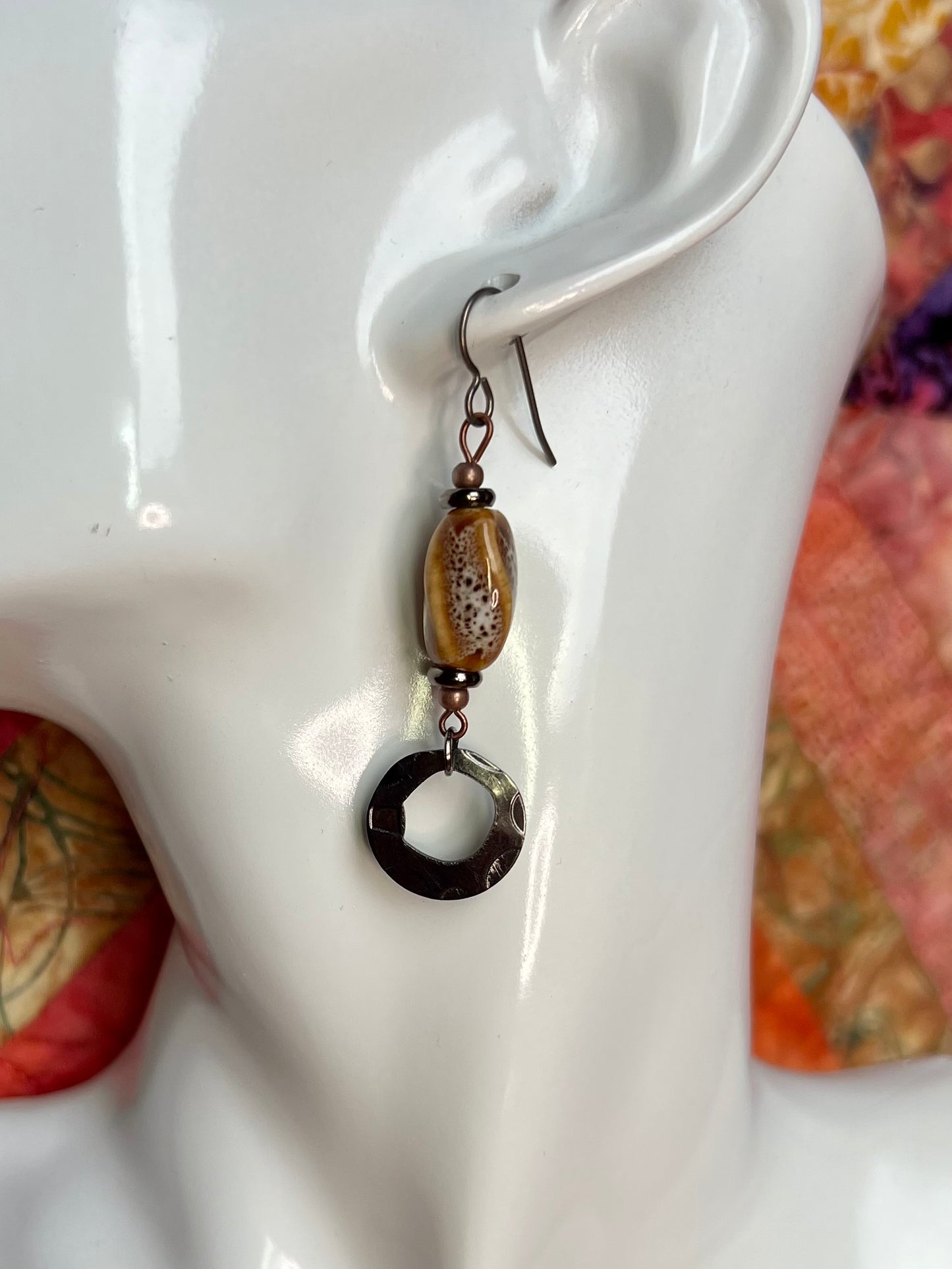 Earrings- Copper and gunmetal plated metal with tan and brown speckled ceramic center bead.