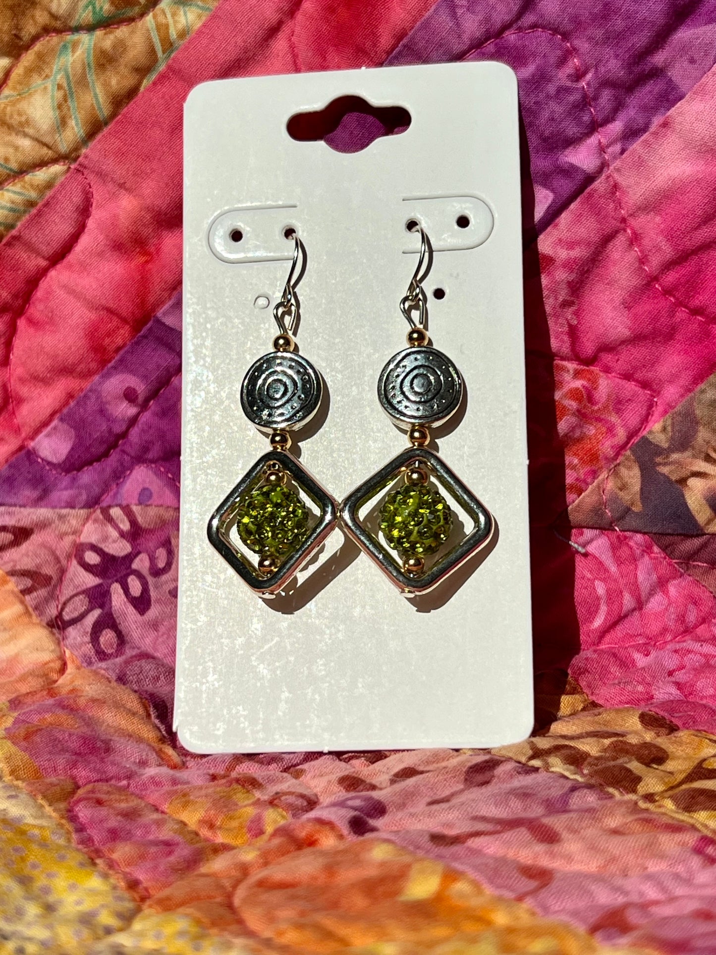 Earrings- Stainless steel ear hooks, antiqued silver plated and gold plated metal beads with lime green clay rhinestone beads.