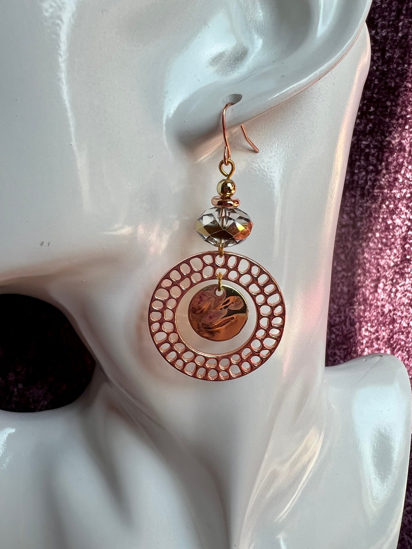 Earrings- Copper and gold plated metal and a clear crystal with a gold stripe in the center.