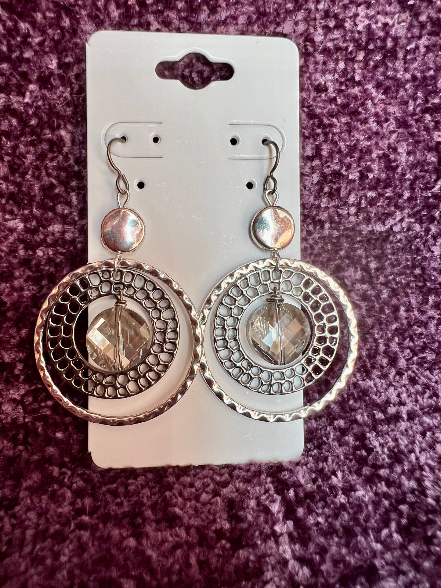 Earrings- Titanium ear hooks with silver and gunmetal plated metal paired with a coin shaped crystal.