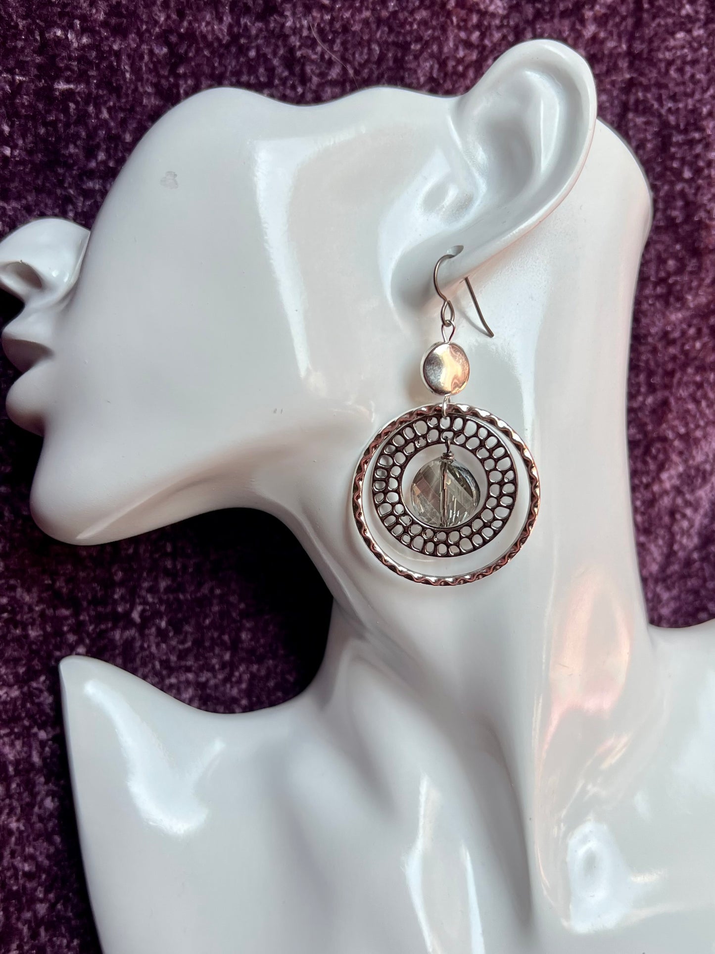 Earrings- Titanium ear hooks with silver and gunmetal plated metal paired with a coin shaped crystal.