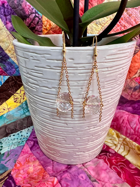 Earrings- Gold plated metal and chain with large clear crystals dangling on the bottom.