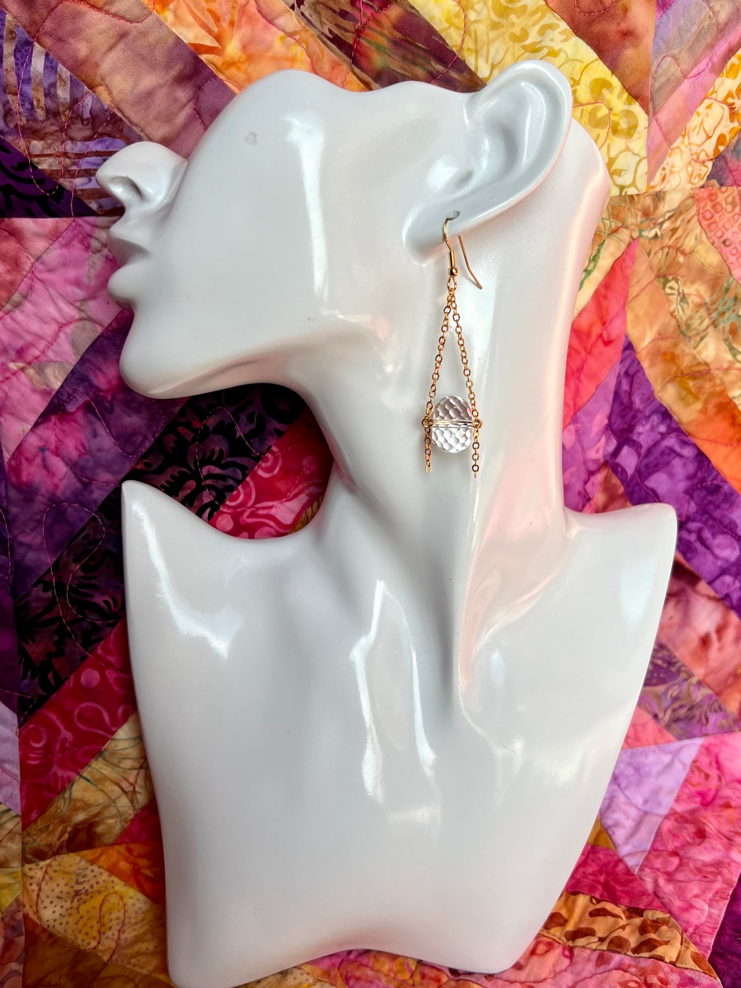 Earrings- Gold plated metal and chain with large clear crystals dangling on the bottom.