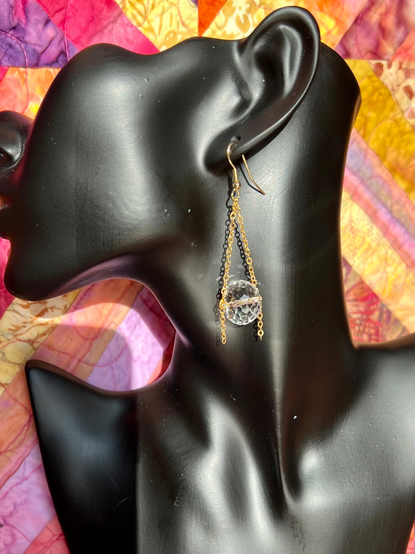 Earrings- Gold plated metal and chain with large clear crystals dangling on the bottom.