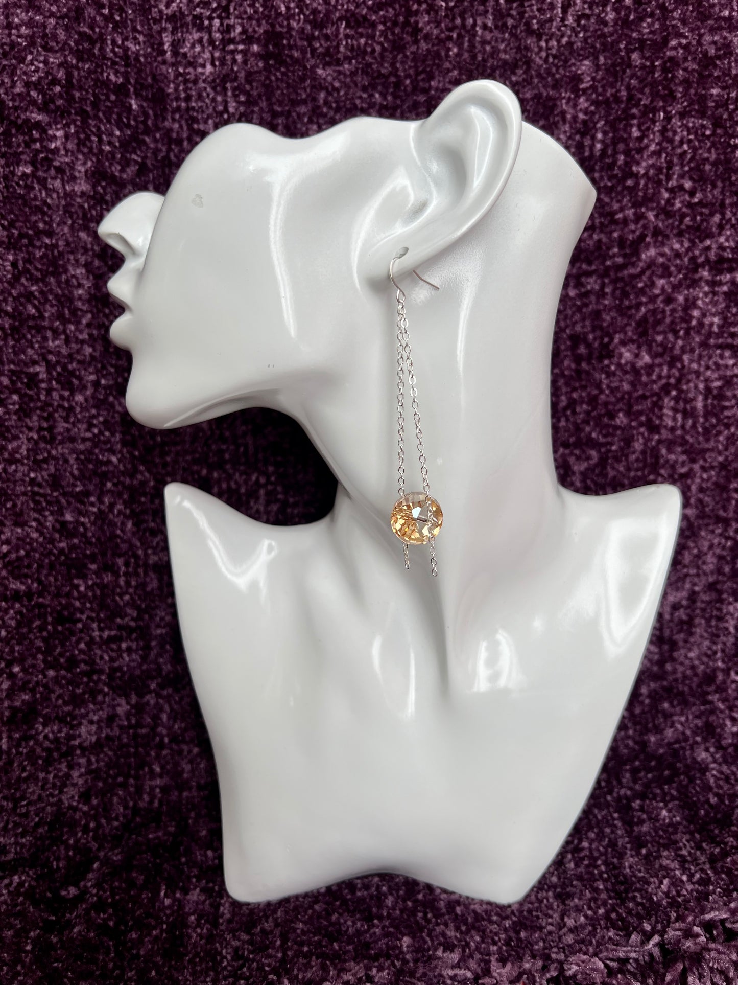 Earrings- Silver plated ear hooks, eye pins, and chain with champagne colored crystals.