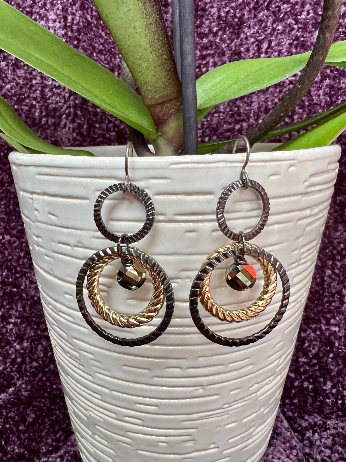 Earrings- Titanium ear hooks with gunmetal and gold plated metal hoops with unique crystals.