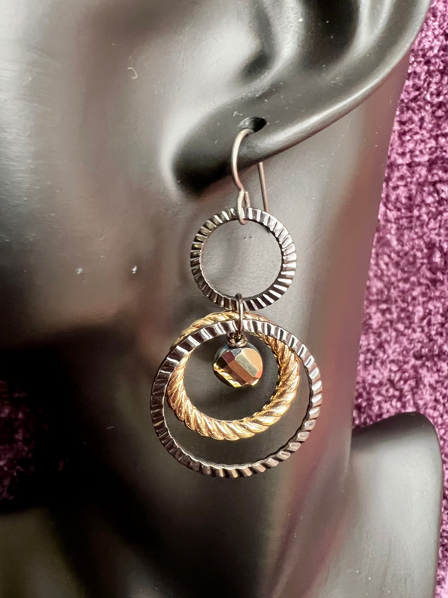 Earrings- Titanium ear hooks with gunmetal and gold plated metal hoops with unique crystals.